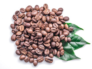 Roasted coffee beans and leaves on white background.