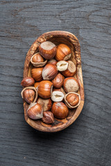 Filberts or hazelnuts in the wooden bowl on the table.