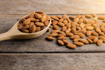 Almonds pour from wood spoon