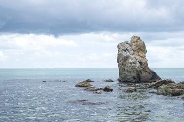 Fototapeta na wymiar Turquoise sea water surface and big rock