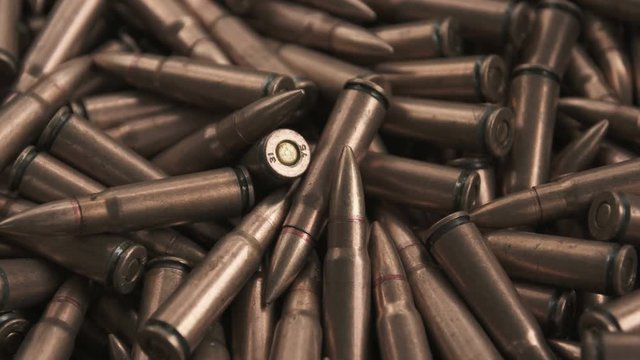 Horizontal panorama of ammunition for ak-47 in color of copper