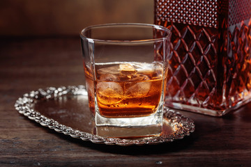 Glass of scotch whiskey and natural ice .
