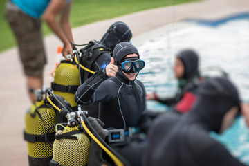 Cheerful diver gesturing thumb up © funkyfrogstock