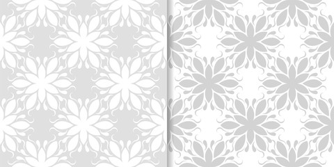 Light gray floral backgrounds. Set of seamless patterns
