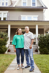 Fototapeta na wymiar Portrait Of Smiling Senior Couple In Front Of Their Home
