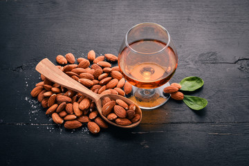 Amaretto Almond Liquor. Almond On a wooden background. Italian drink Top view. Free space for text.