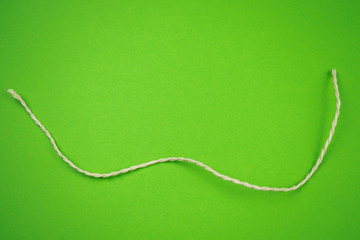 String on colorful green background, copy space