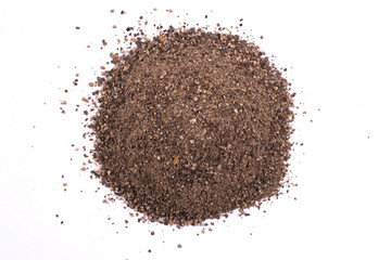 A pile of a  dry black pepper powder isolated on white background
