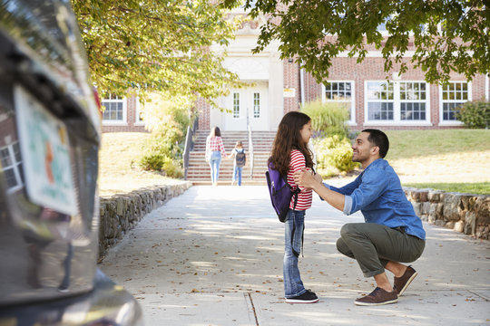 Father Dropping Off Daughter In Front Of School Gates