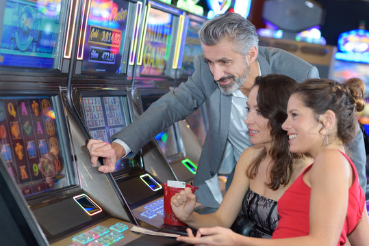 group of people playing at a slot in a casino