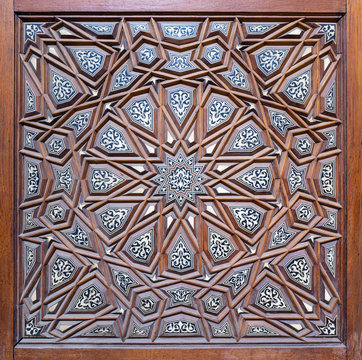 Closeup of arabesque ornaments of an old aged decorated wooden door