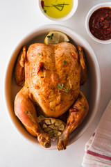  Roasted chicken with garlic, lemon, thyme and rosemary.