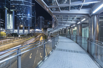 Modern pedestrian walkway in midtown of Hong Kong city at night