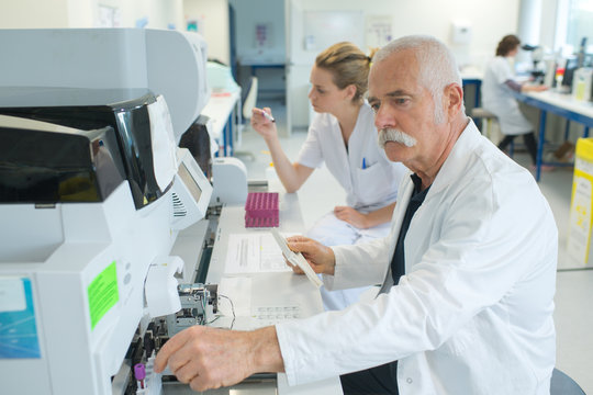 senior male researcher carrying out scientific research in a lab