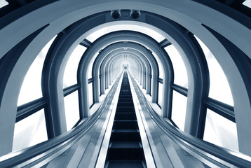 Futuristic tunnel and escalator of steel and metal, interior view. Futuristic background
