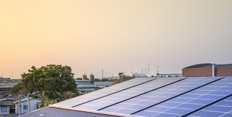 Solar panel energy on the industrial roof with sunset sky background