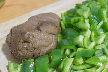 cooking seitan with spelled and green peppers