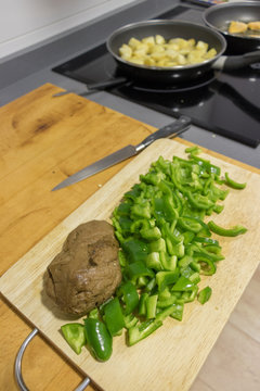cooking seitan with spelled and green peppers