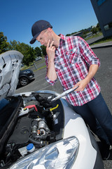 mechanic inspecting the cars engine