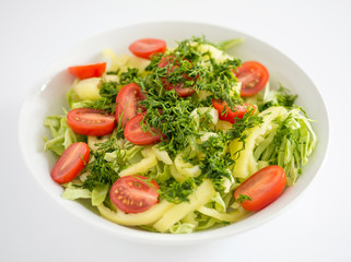 White round plate with vegetable salad. Raw food
