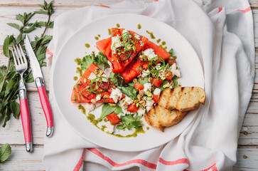 Watermelon salad with fresh cheese and mint dressing