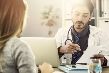 Female patient listening to doctor in medical office