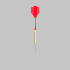 Isolated Red Playing Dart on a Light Reflective Surface