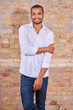 Portrait of a happy handsome young man in a white shirt.