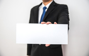 Business man hold blank white paper on hand with isolated white background