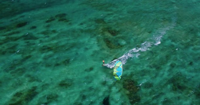 Cinematic aerial view of kiteboarder