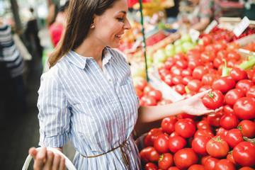 Picture of woman at marketplace buying vegetables