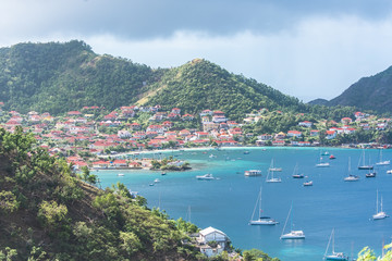 Fototapeta na wymiar Terre-de-Haut Island in Guadeloupe, panorama of typical houses, the harbor in the bay with sailboats 