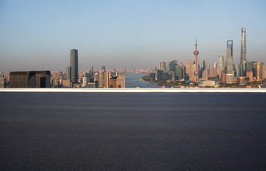 Fototapeta na wymiar Empty road floor surface with city landmark buildings at Shanghai Skyline