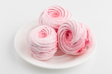 Fototapeta na wymiar Homemade pink zephyr or marshmallow isolated on white