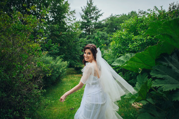 Woman in white poses in the garden