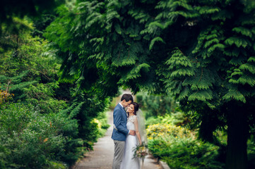 Look from above at beautiful wedding couple kissing in the eveni