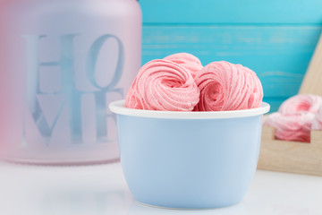 Homemade pink zephyr or marshmallow on blue bowl