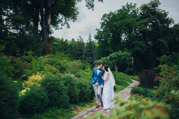 Look from above at beautiful wedding couple kissing in the eveni