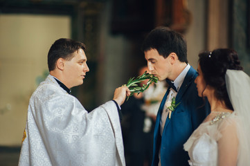 beautiful and young couple on wedding ceremony in church