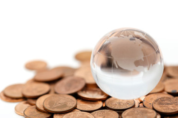 mini glass globe close up with stack of coins using as background,world business concept.