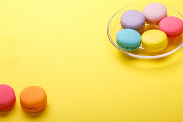 Colorful macaroons on yellow background. Sweet macarons. copy space for your text