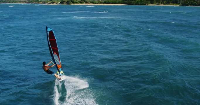 Cinematic aerial view of windsurfer