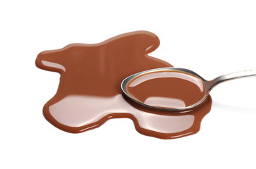 Spilled chocolate milk puddle and metal spoon isolated on white background