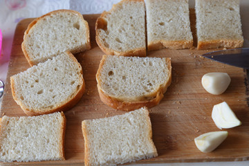 Slices of toast bread on wooden table, top view