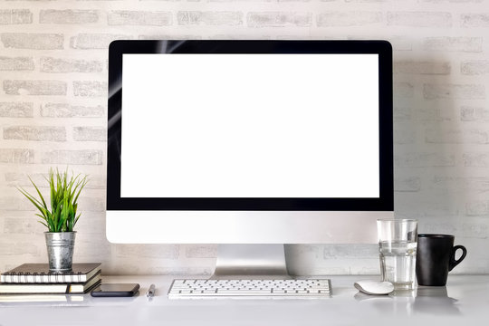 Modern clean workspace mockup with blank screen desktop computer and office supplies.