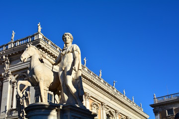 Naklejka premium Marble statues of the Dioscuri, Castor and Pollux, at the top of the staircase, with Capitol Square or Piazza del Campidoglio in background. Rome, Italy.
