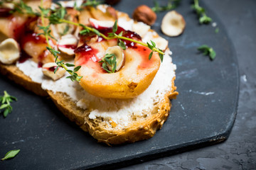 Bread with ricotta cheese and pears on the wooden background. Shallow depth of field.