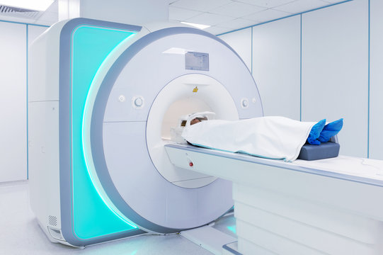 Female patient undergoing MRI - Magnetic resonance imaging in Hospital. Medical Equipment and Health Care..