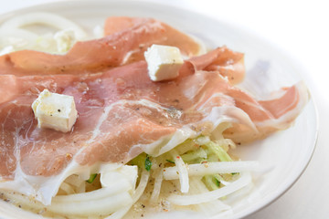 prosciutto ham with cheese and salad in white background