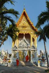 a number of  monks are waliking in to ordination hall for Evening Chant at Wat Bang Pai, Nontaburi...